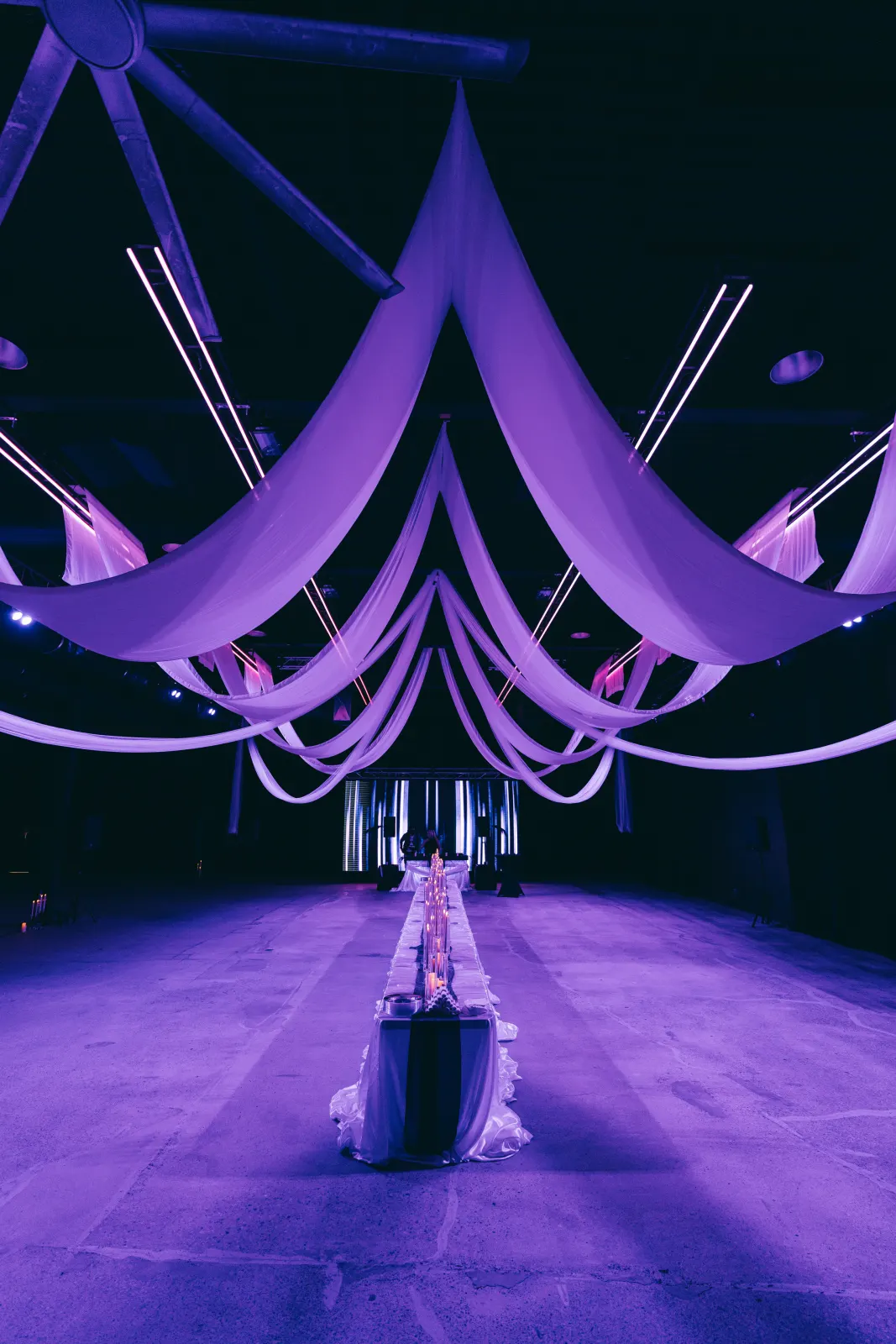 Draped fabric ceiling installation above the candlelit dinner table, video still