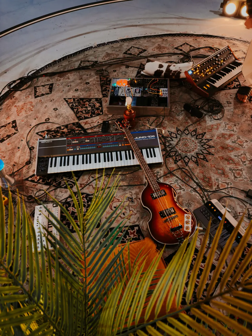Overhead detail of the synth and modular gear setup on the rug