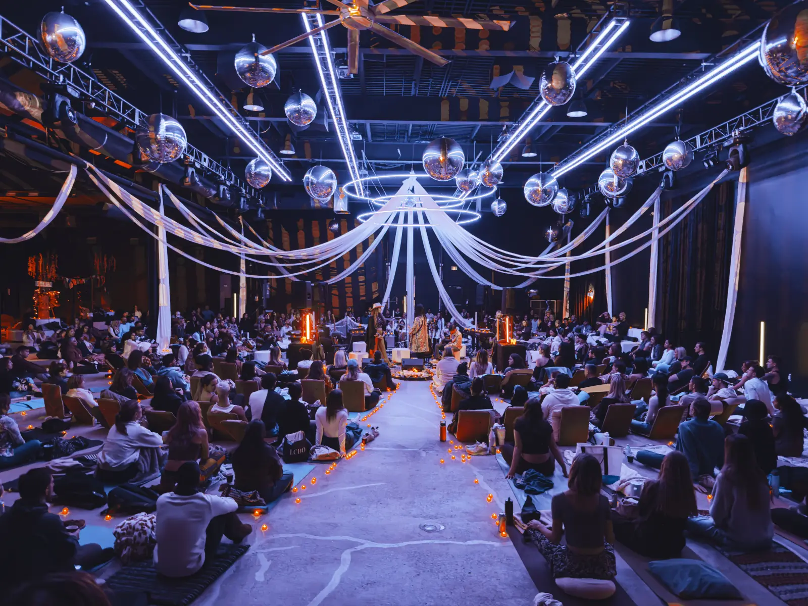 Soul Expansion wellness experience, guests seated around a glowing centerpiece