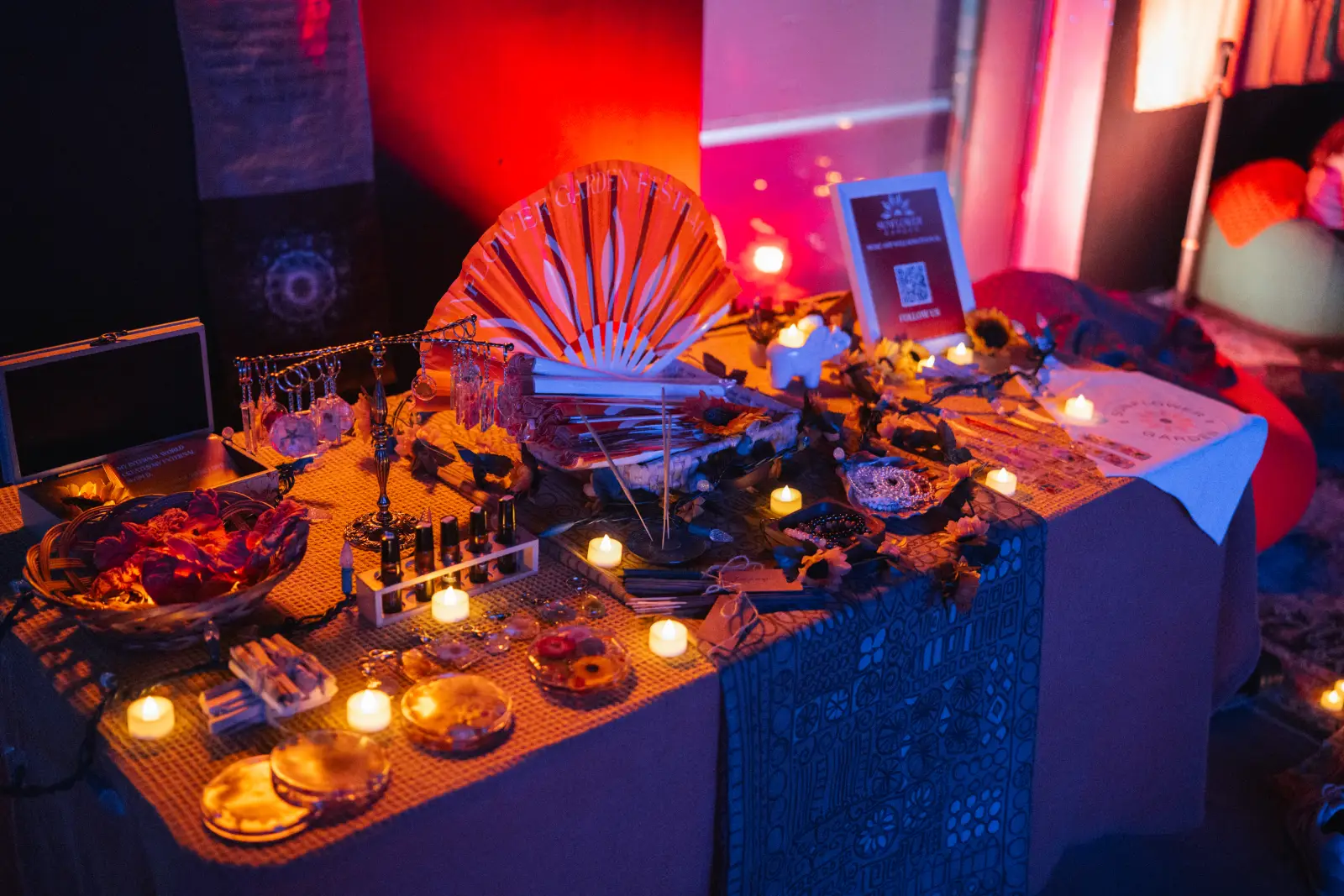 Wellness vendor pop-up table with candles and market goods