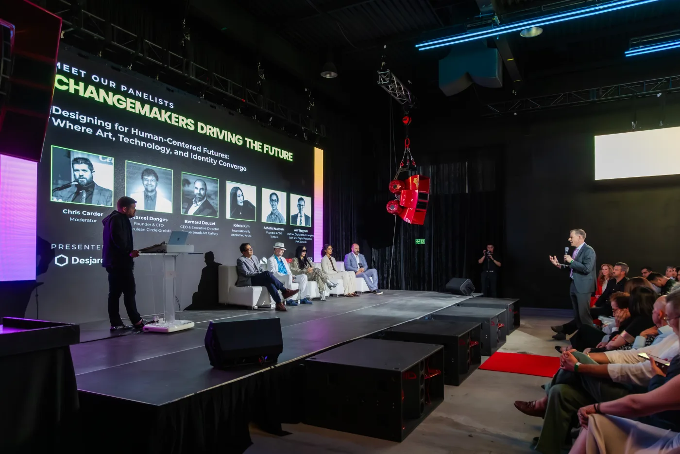 A panel discussion on stage at Demo Room, VOID speakers visible on the floor